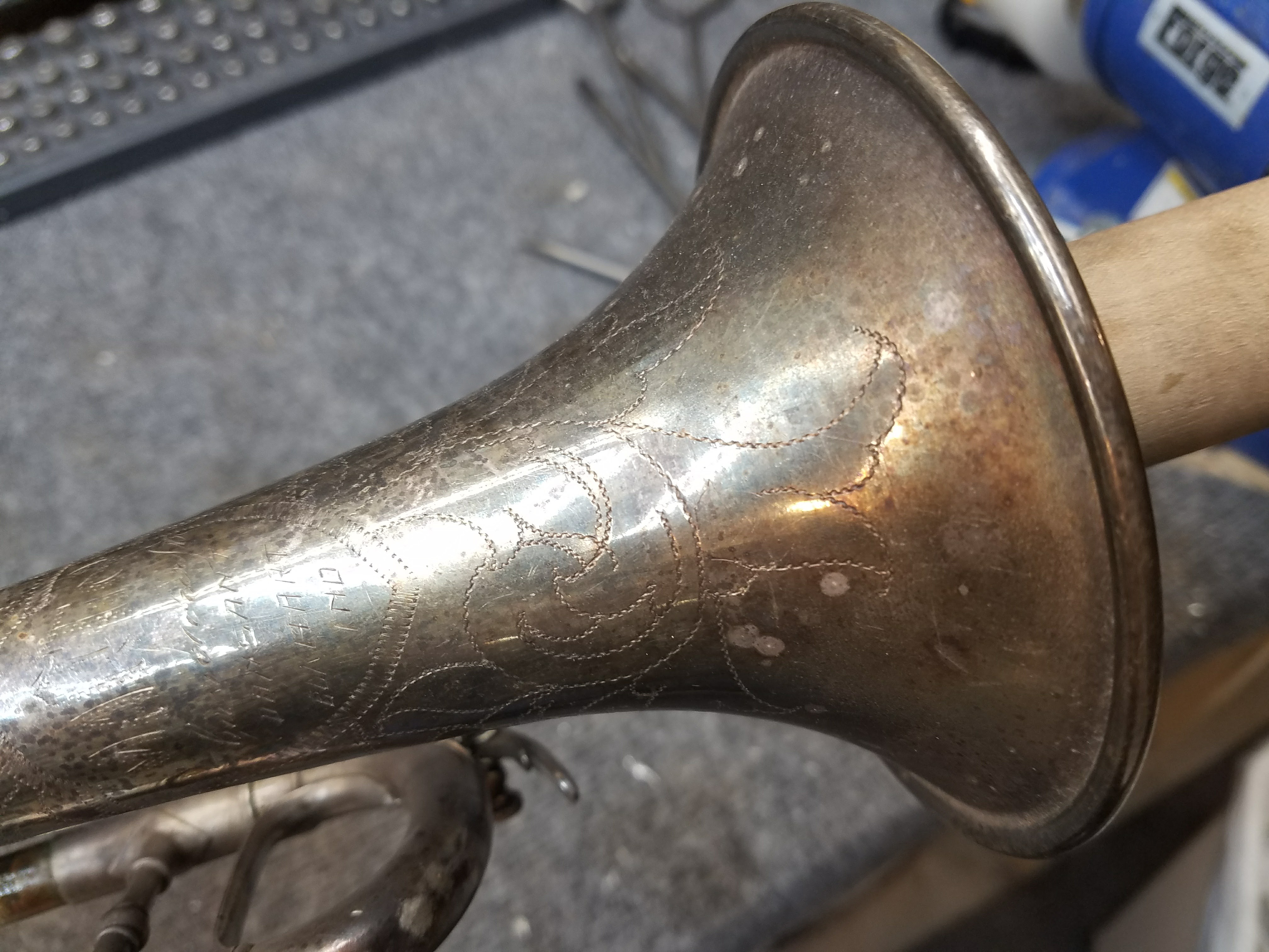 Bell before restoration — ornate engraving obscured by tarnish