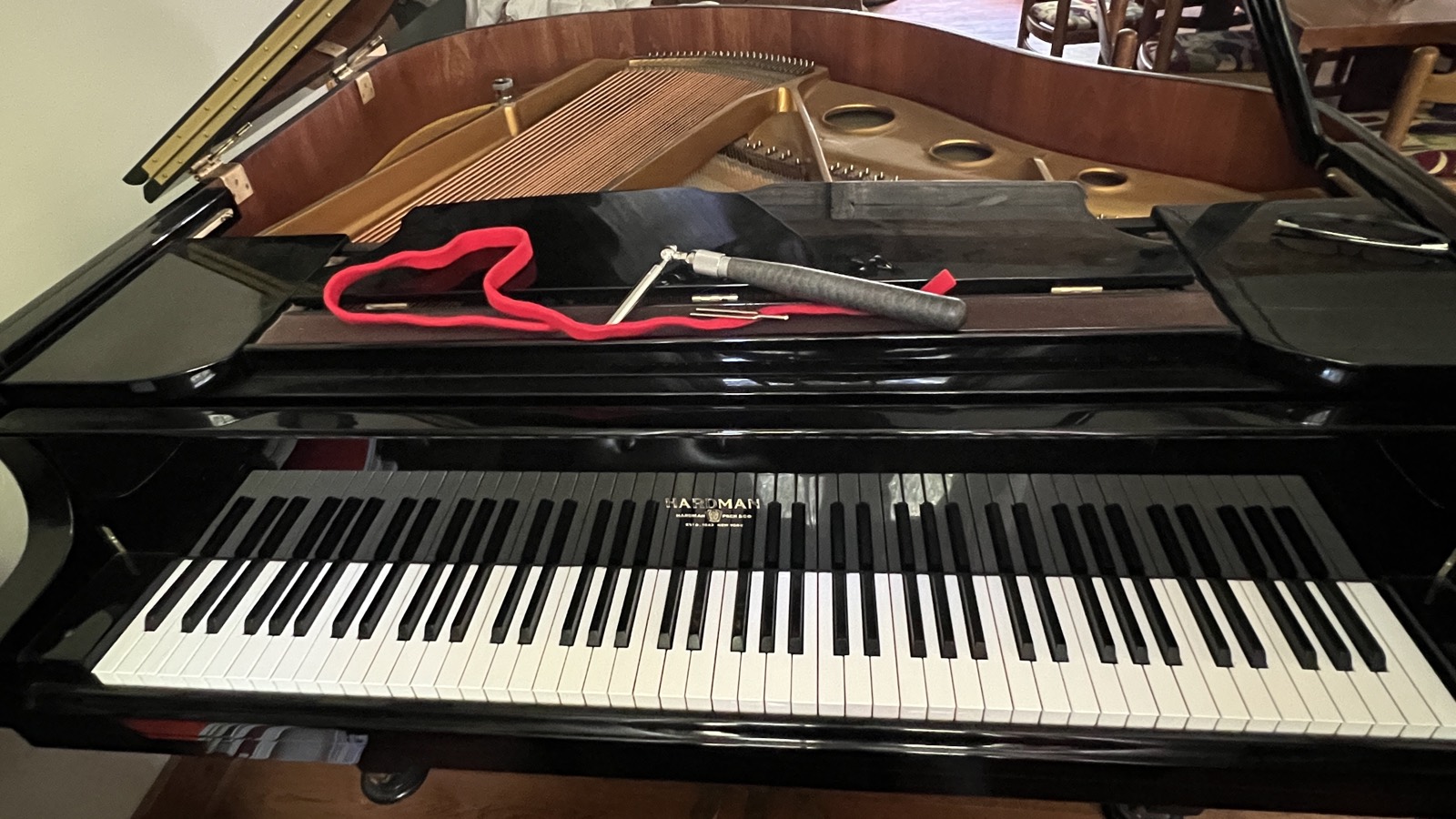 A Hardman grand piano with tuning tools laid on top