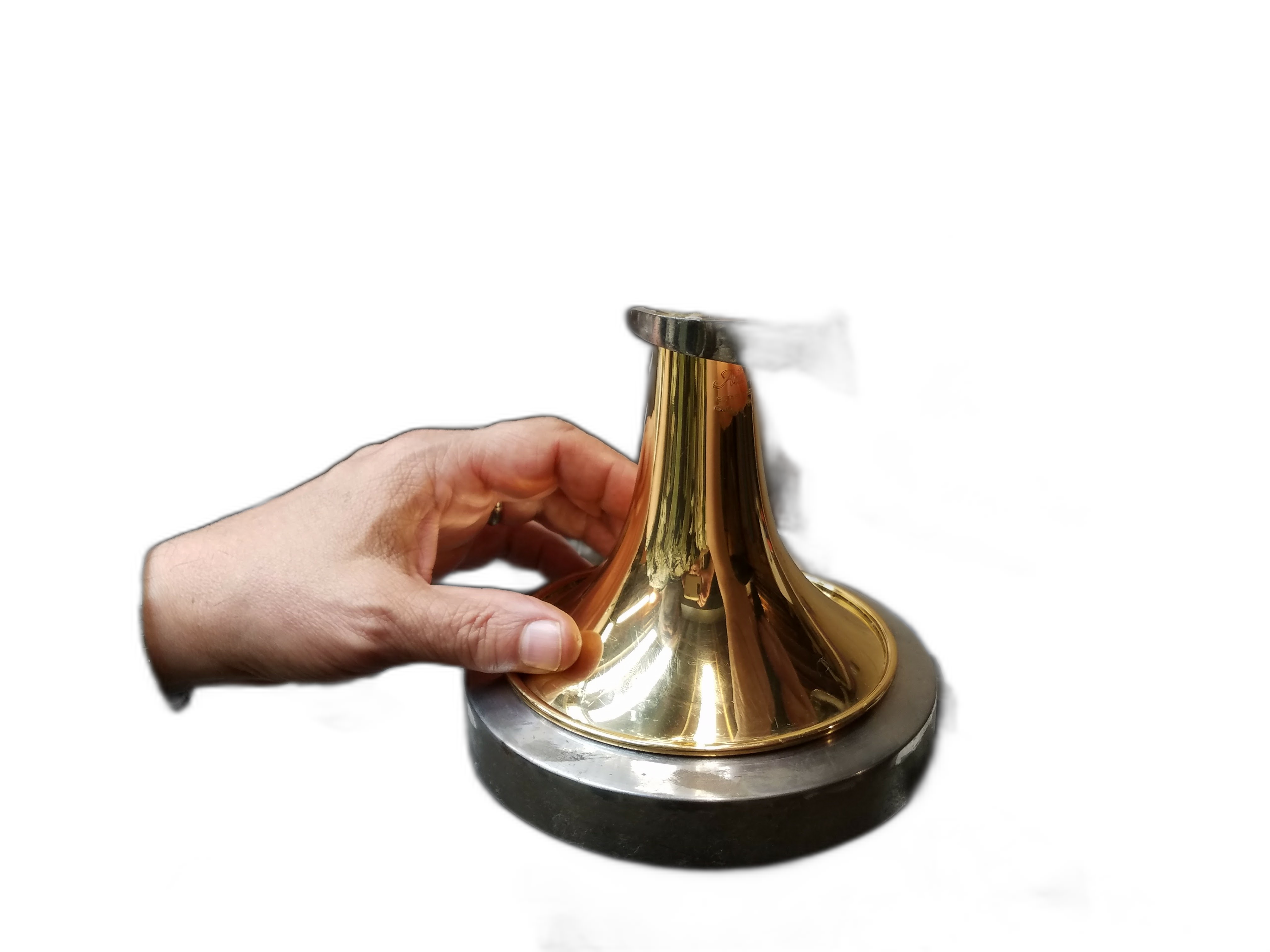 Hands working on a trumpet bell