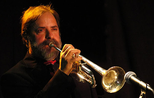 Rob Fisch playing trumpet on stage