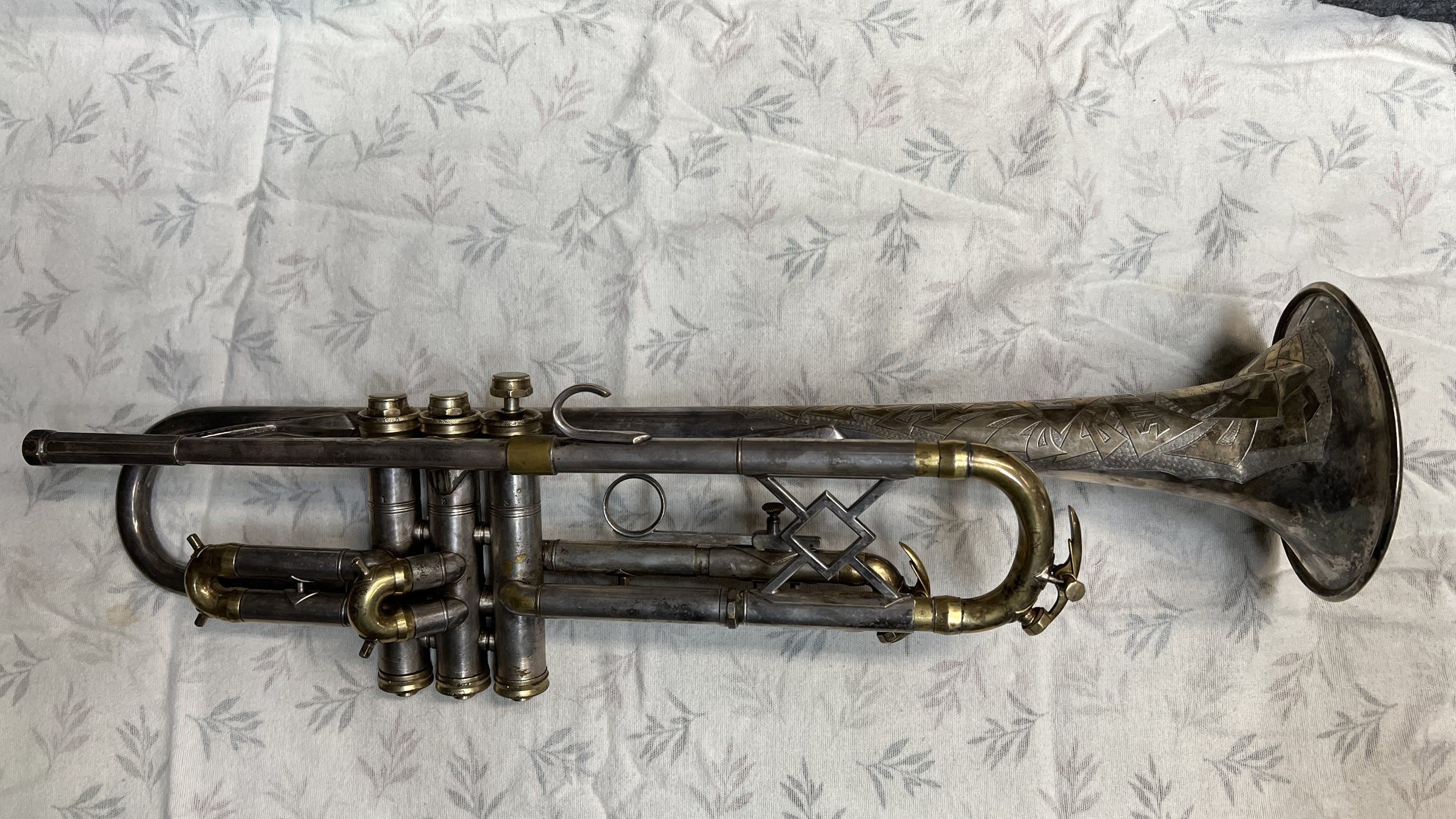 The trumpet before restoration, dark with tarnish